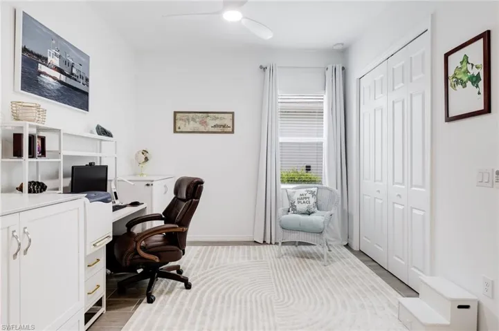 Office area featuring light wood-type flooring and ceiling fan
