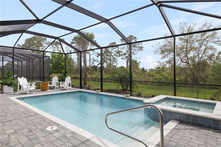 View of pool featuring an in ground hot tub, a lanai, and a patio area
