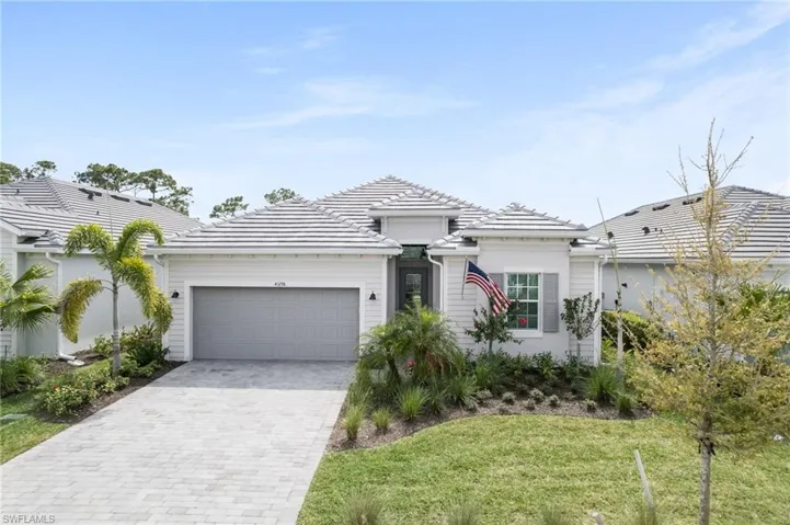 View of front of home with a front yard and a garage