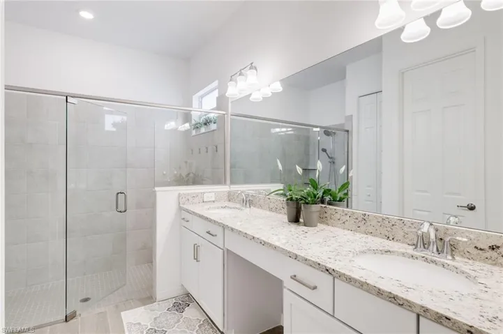 Bathroom with vanity and a shower with shower door