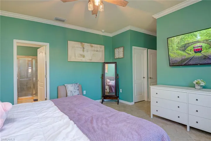 Room with tile flooring, crown molding, and a ceiling fan with integrated lighting