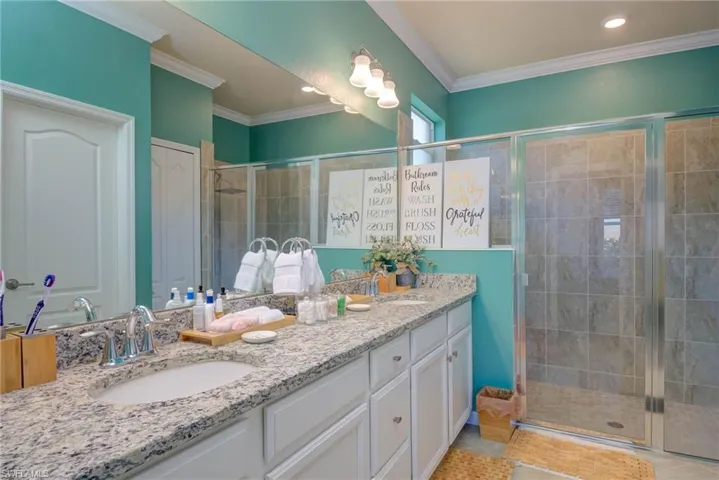 Double vanity with an undermount sink, stone countertop, and chrome faucet fixtures