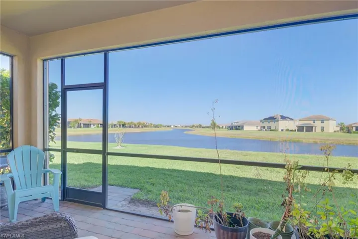Screened lanai featuring a paver patio and expansive waterfront views