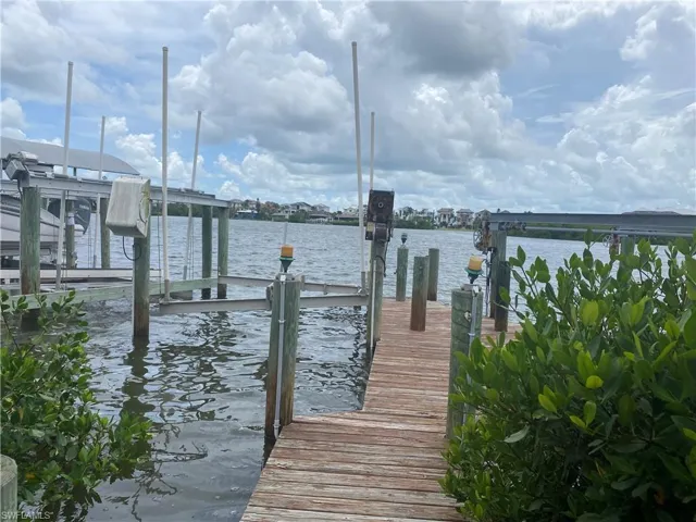 Dock featuring boat lift and a water view