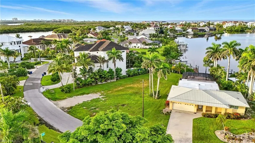 Aerial view of residential area featuring a nearby body of water
