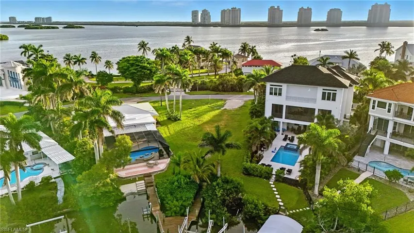 View of urban area with a pool area and a nearby body of water