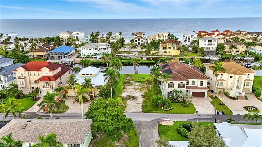 Aerial perspective of suburban area with a nearby body of water