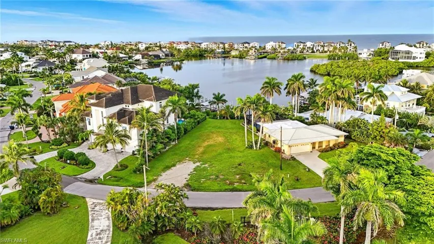 Aerial perspective of suburban area with a nearby body of water