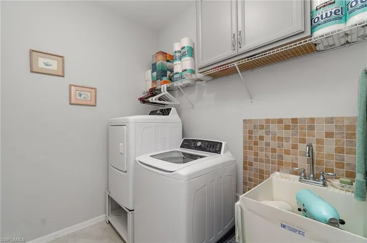 A sizeable 8' x 6' laundry room with laundry tub