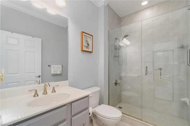 The guest bathroom is clean, modern & convenient with an easy access stand-up shower
