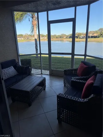 Sunroom / solarium featuring a water view