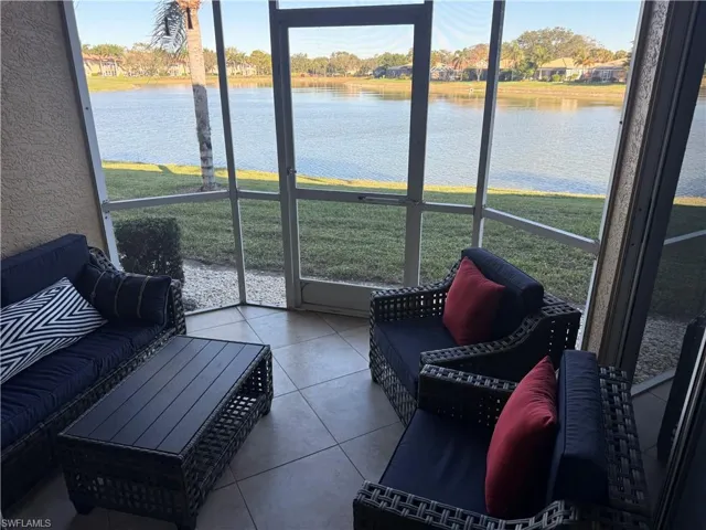 Sunroom featuring a water view and outdoor furniture