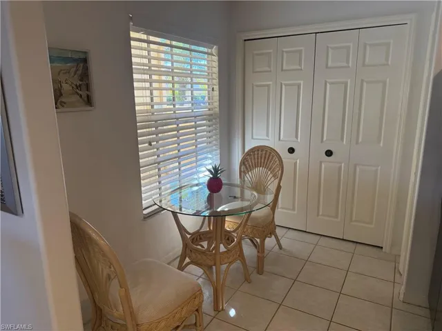 Dining space featuring light tile patterned floors and baseboards