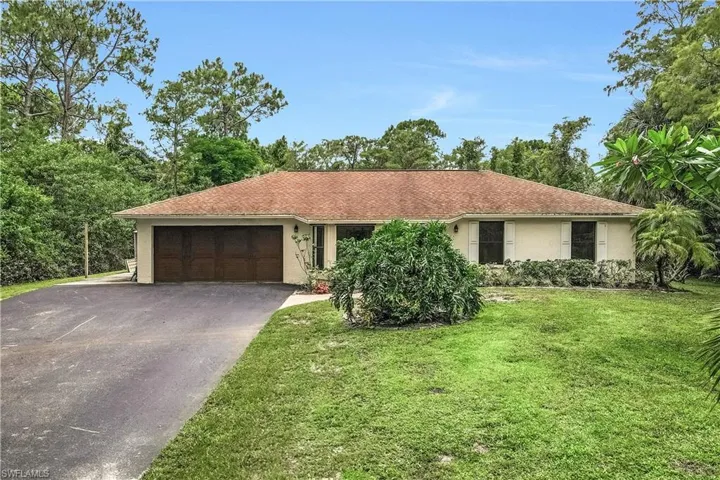 Ranch-style home with a garage and a front yard