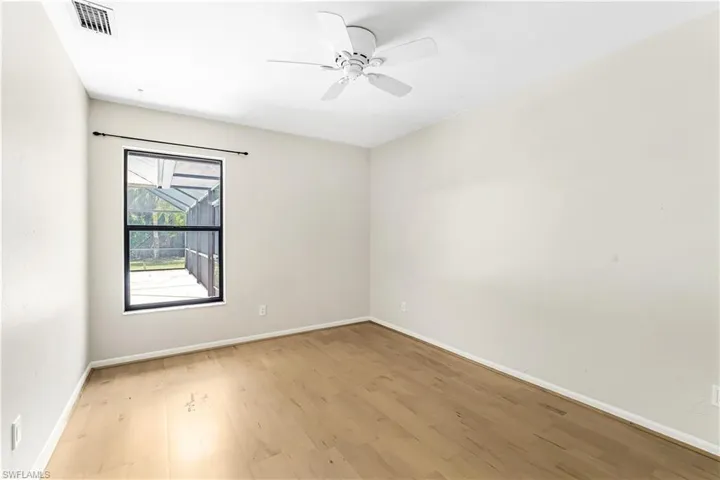 Spare room with light wood-type flooring and ceiling fan