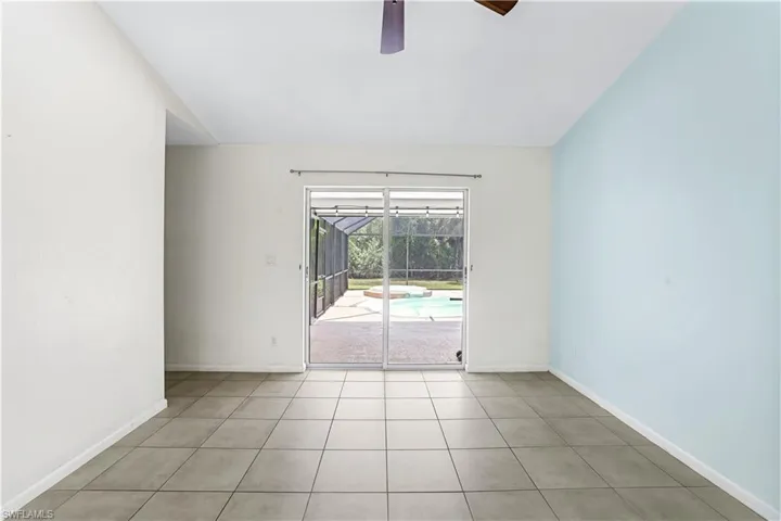 Tiled empty room with ceiling fan