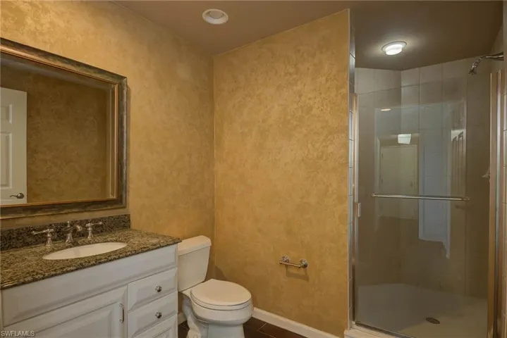 Bathroom featuring a stall shower and vanity