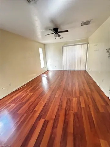 Unfurnished room with wood finished floors and ceiling fan