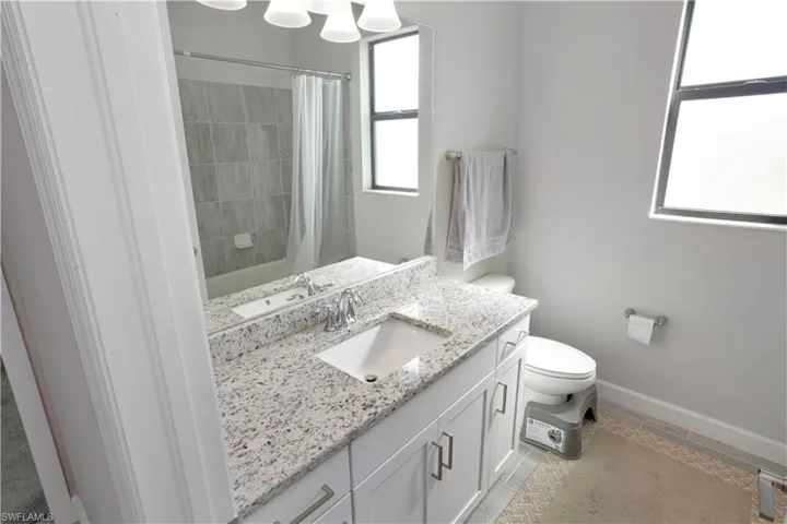 Full bathroom featuring vanity and shower / bath combo with shower curtain