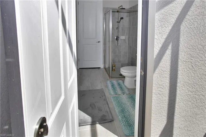Bathroom with a shower stall and toilet