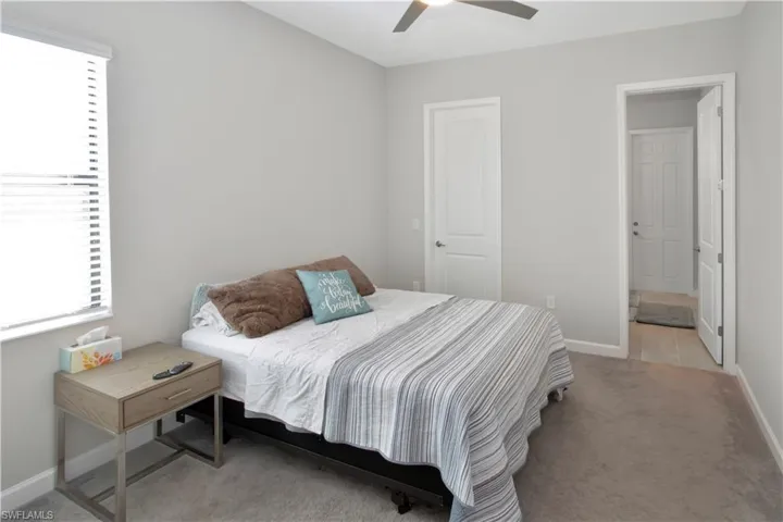 Bedroom featuring light carpet and ceiling fan