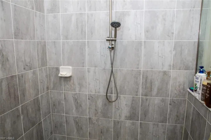 Full bath with a tile shower