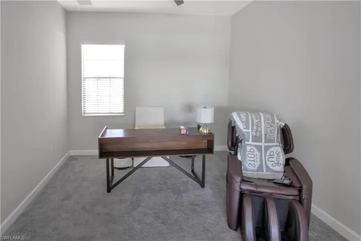 Carpeted office with baseboards