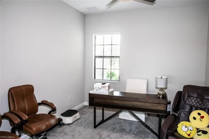 Office space with carpet and ceiling fan