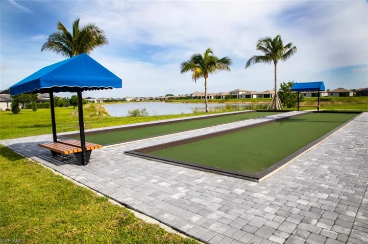 View of home's community with a game area, a yard, a water view, and a residential view