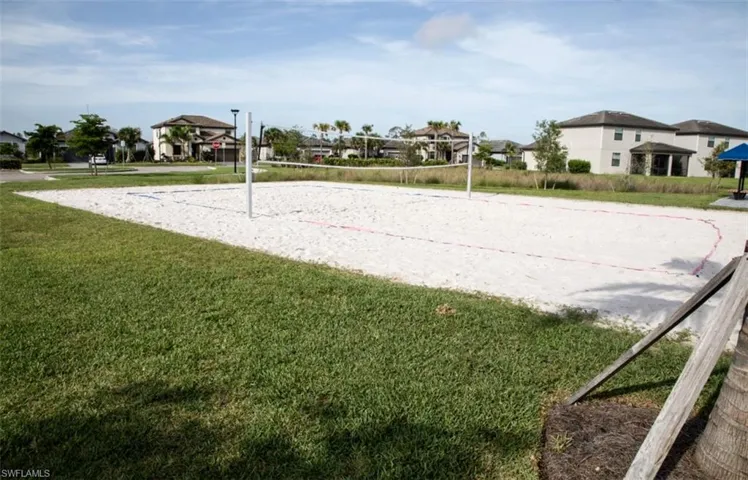 View of property's community featuring a lawn and volleyball court