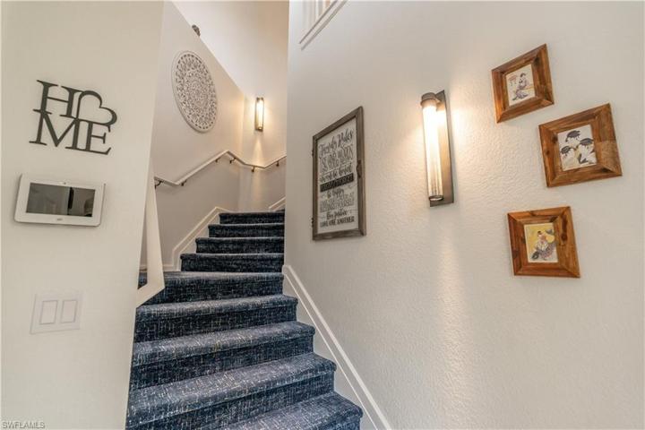 Inviting entrance stair with luxurious blue carpet