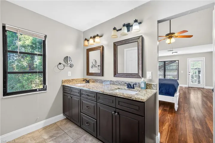 Dual vanity with granite countertop and framed mirrors