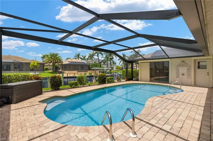 View of pool with a patio and a lanai