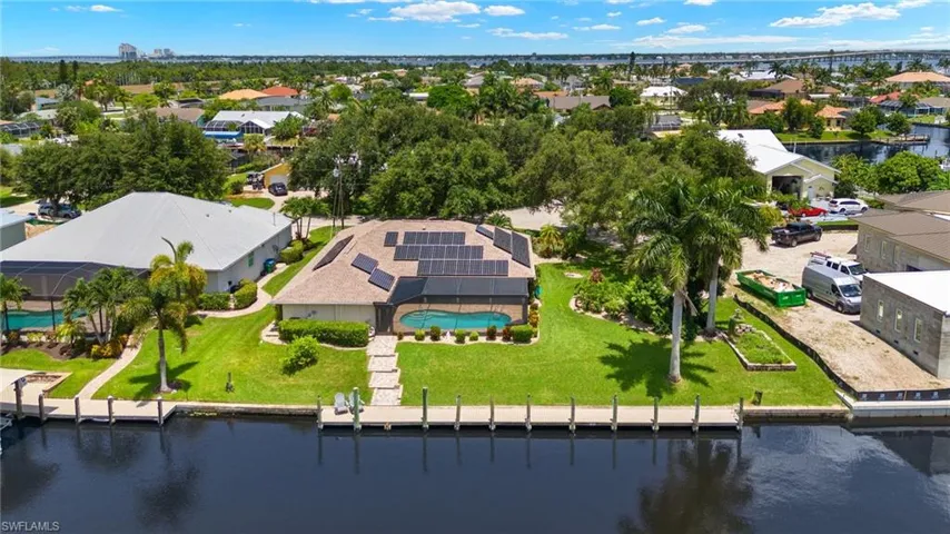 Birds eye view of property with a water view