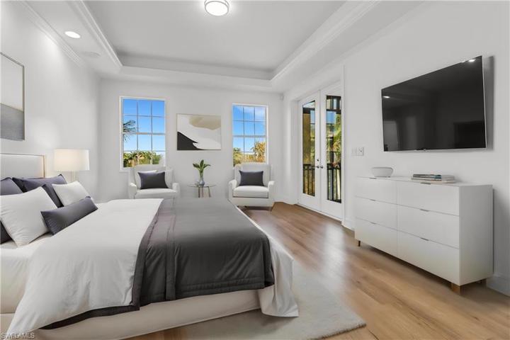 Master bedroom, highlighting view of the lake, crown molding indoors leading to the rear lanai