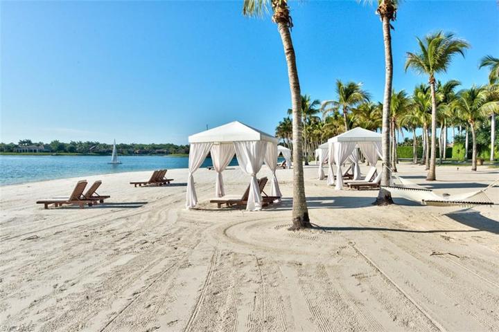 Beach area with cabanas and rentable, kayaks, paddle boards and sailboat