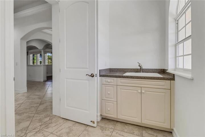 Utility sink in Laundry room with large storage closet