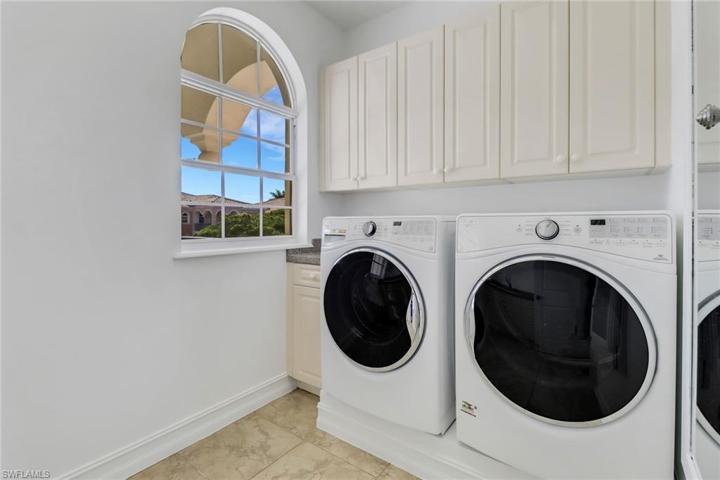Laundry room with built-in ironing board and separate utility sink
