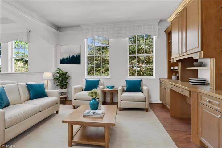 Open concept den with built in desk and custom valances and crown molding