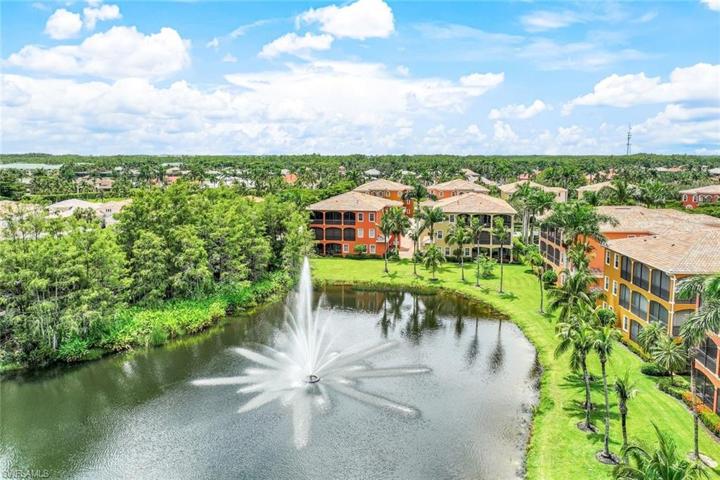 View of the property showing the lake and fountain