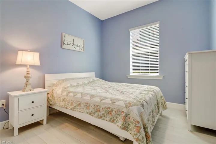 Bedroom with light hardwood / wood-style flooring