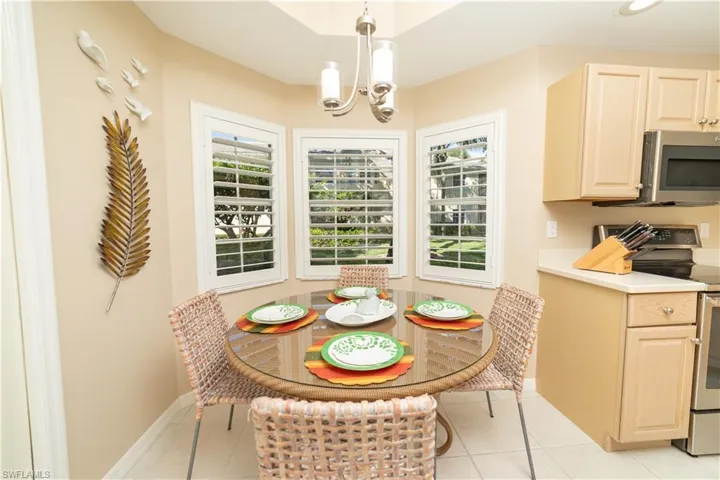 Dining space featuring light tile patterned flooring and a chandelier
