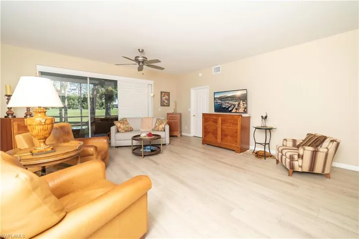Living room with light wood finished floors and a ceiling fan