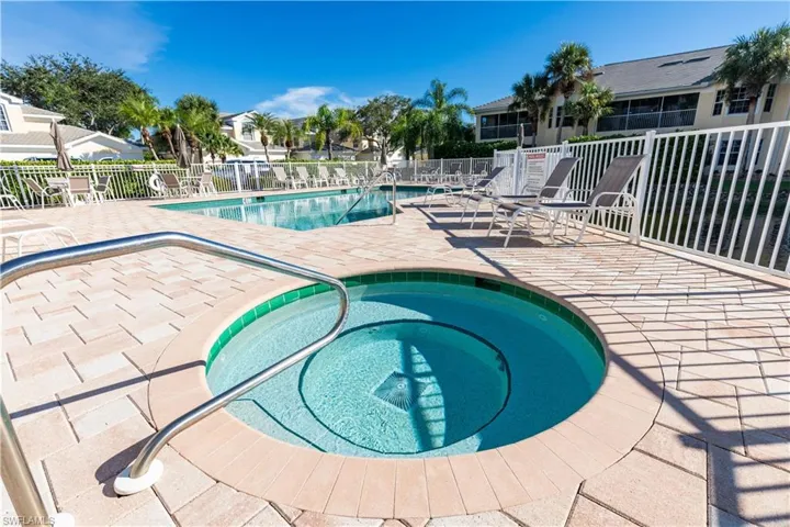 Community pool featuring a patio area and a hot tub
