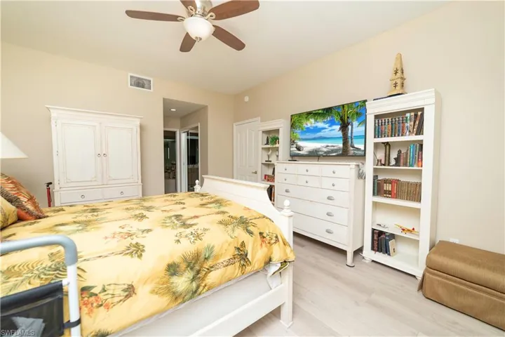 Bedroom featuring light wood-style floors, ceiling fan, and a closet