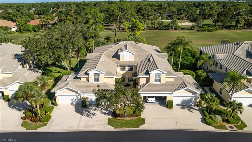 Aerial view of property and surrounding area featuring a golf club