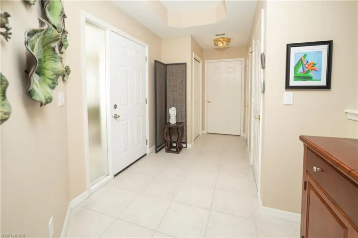 Corridor with light tile patterned floors