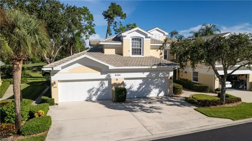 Traditional-style home featuring concrete driveway, stucco siding, a garage, and a tile roof