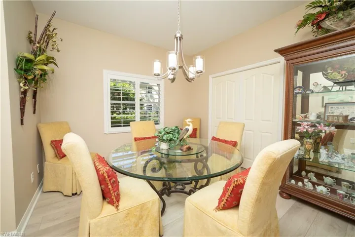 Dining space featuring wood finished floors and a chandelier
