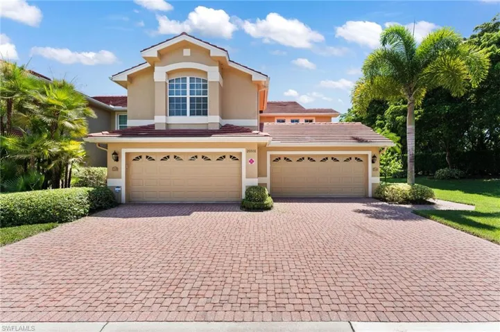 Mediterranean / spanish-style house featuring a garage and a front lawn